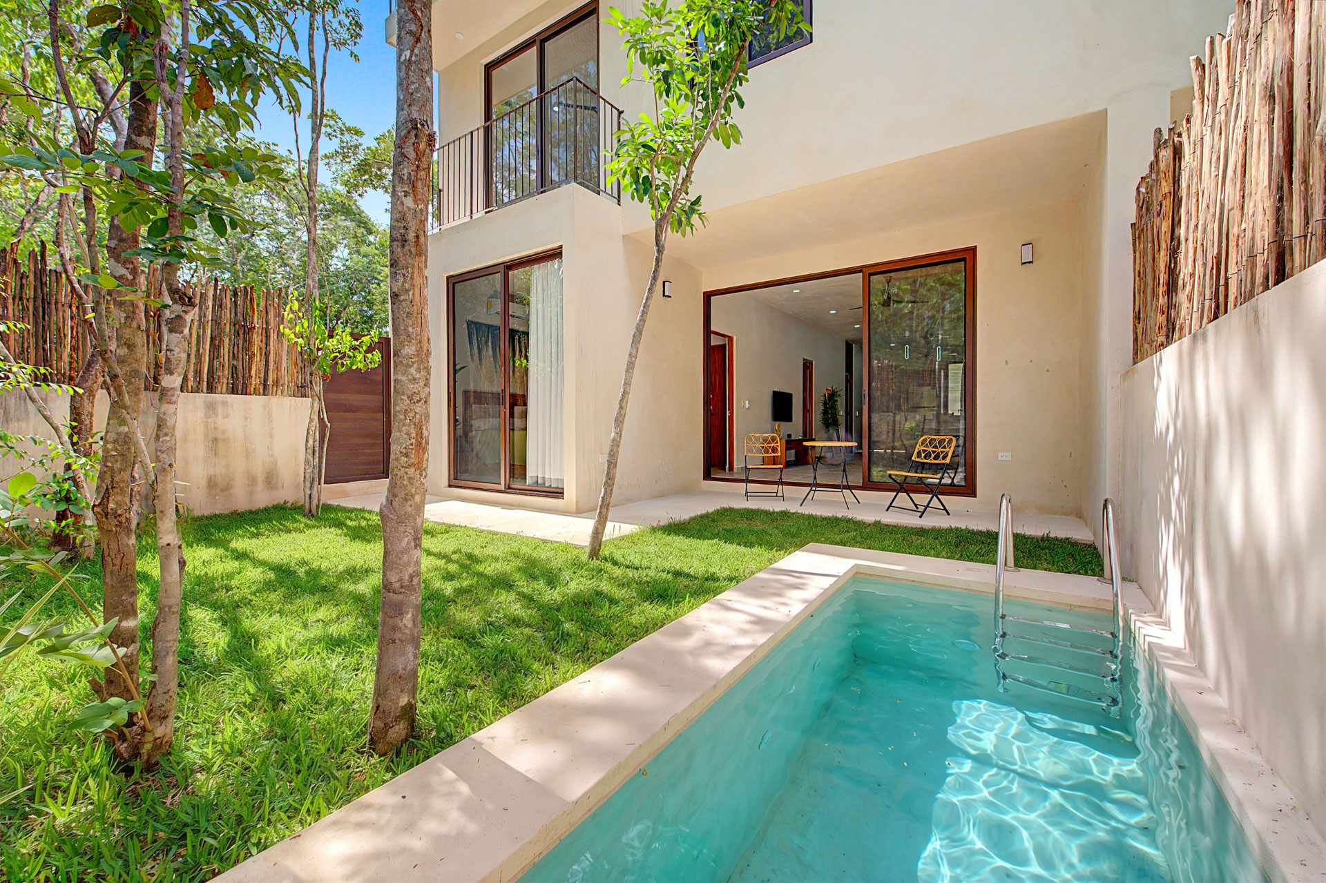 Swimming pool and lush tropical garden at Tulum Gardens, Tulum Mexico