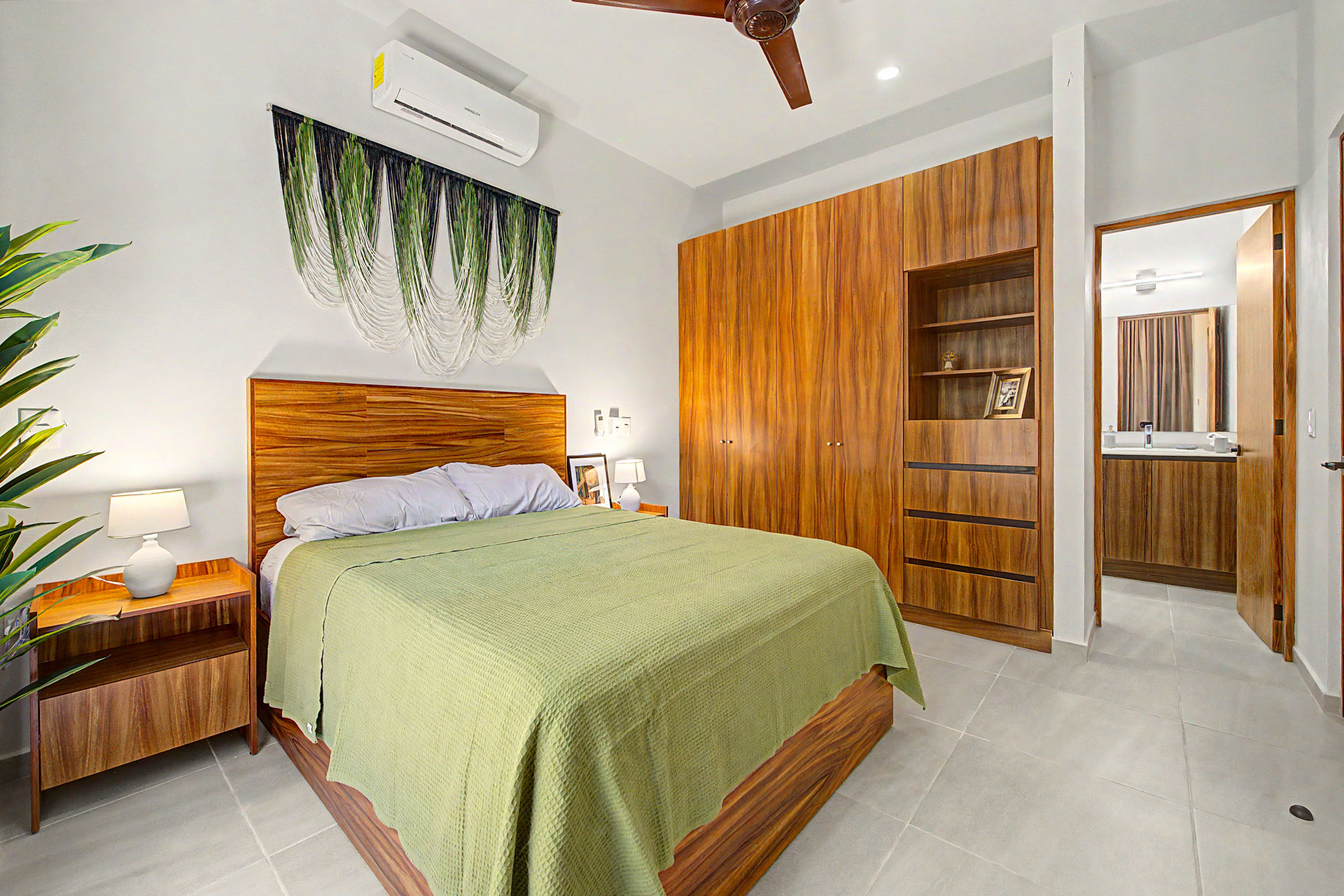 Main bedroom with ensuite and wood wardrobe in a Tulum Gardens townhouse
